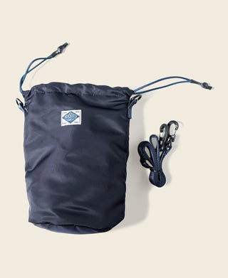 Navy nylon chalk bag with drawstring closure and small logo patch