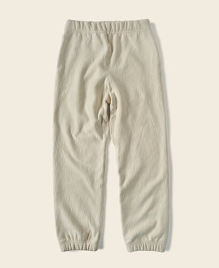 Light cream sweatpants, front view; elastic waistband and tapered leg cuffs