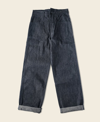 Dark navy denim pants laid flat with straight legs and rolled cuff hem