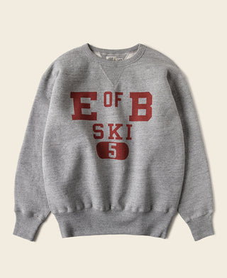 Gray V-neck pullover ski sweater with bold red sports graphic on the front