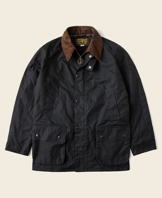 Black waxed chore jacket front with brown corduroy-style collar and snap buttons