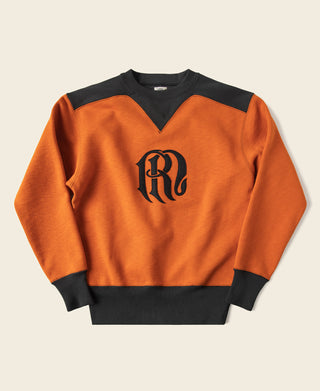 Orange and dark V-inset two-tone sweatshirt with black collar and front logo graphic.