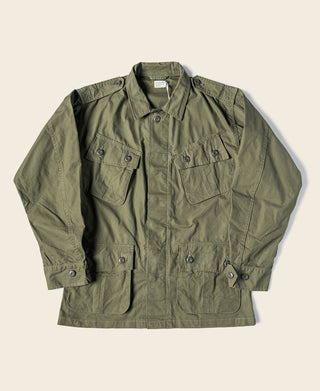 Olive fatigue jacket with button-front, stand collar, and chest flap pockets