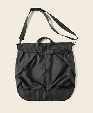 Black nylon helmet bag with wide shoulder strap and front panel pockets