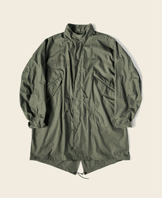 Olive M-65 style parka with stand collar, front zipper, and flap pockets