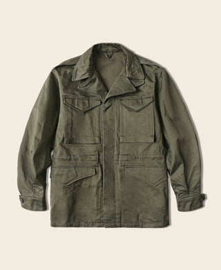 Olive M-1943 field jacket with button front and chest flap pockets