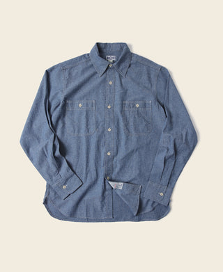 Blue chambray button-up work shirt with two chest pockets and button front