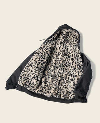 Reversible deck jacket showing leopard print fleece and black outer side