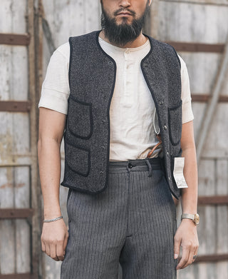Men's dark salt-and-pepper wool vest with flap pockets and buttoned front