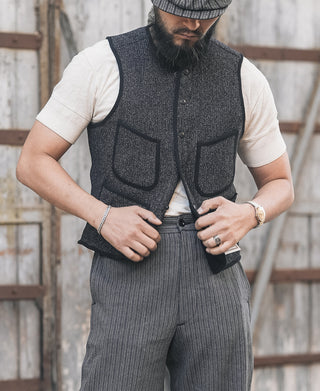Men's dark salt-and-pepper wool vest with front buttons and two flap pockets