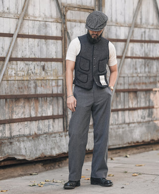 Men's dark salt-and-pepper wool vest worn with matching dark striped trousers
