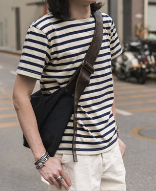 Breton striped T-shirt worn by model, cream and navy horizontal stripes, crew neck short sleeves