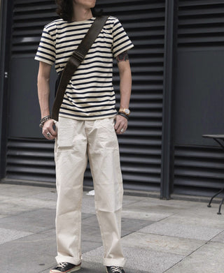 Breton striped T-shirt worn by model, cream and navy horizontal stripes, short-sleeve crew neck