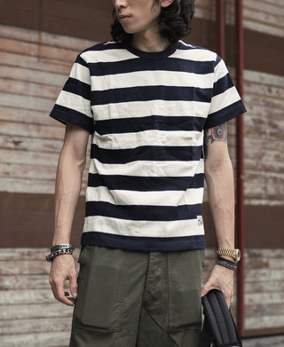 Men's heavyweight cotton wide-striped t-shirt with navy and white stripes, worn with pants