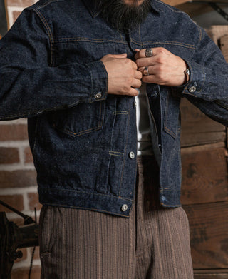 Indigo selvedge denim jacket worn by person, front buttoned, long sleeves