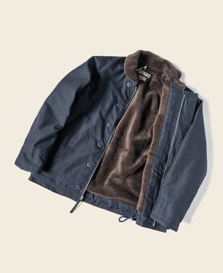Navy deck jacket open front showing dark fur lining and button placket