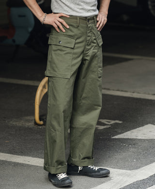 Olive fatigue trousers with front cargo flap pockets and straight relaxed legs