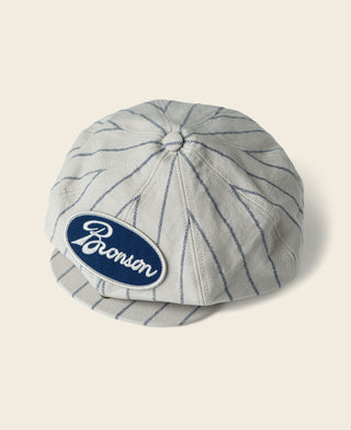 Gray railroad stripe newsboy cap with Bronson logo patch on crown