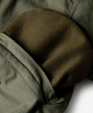 Olive M-65 parka with dark fleece-lined collar area