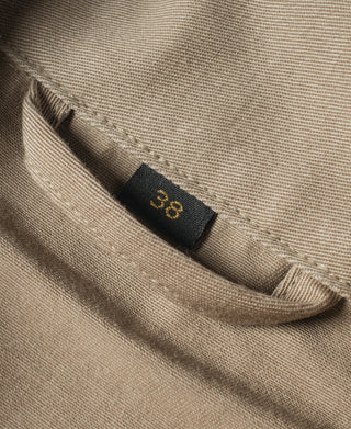 Khaki jacket interior size label near collar seam