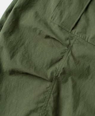 Olive shell arctic trousers, stitched seam and folded fabric panel detail