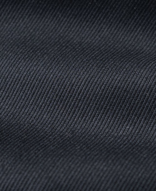 Navy deck jacket fabric close-up with fine ribbed texture