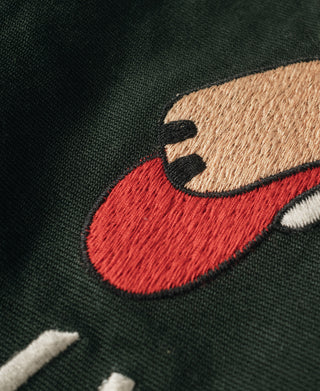 Fox embroidery on dark green jacket with red nose and black outline