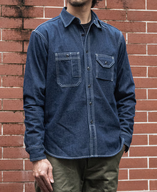 Denim workshirt on model with button-front and two flap chest pockets, dark blue