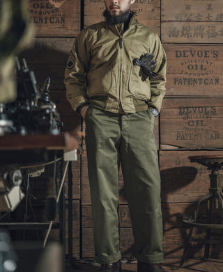 US Army 1st tanker jacket in olive green, standing view with front zipper and chest pockets