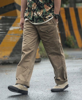 Khaki military trousers with side pockets and slanted front pocket opening