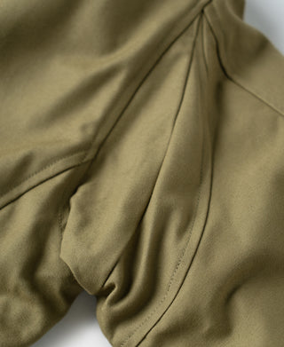 Khaki flight jacket front panel with stitched seams and overlapping flap detail