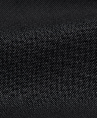 Black textured deck jacket fabric close-up, woven pattern