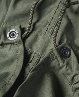 M-65 parka olive with snap buttons, drawstring cord, and circular patch detail