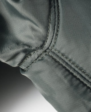 Olive MA-1 flight jacket, stitched hem edge with binding and reinforcement seam
