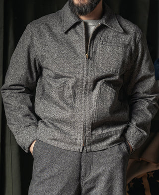 Salt-and-pepper cossack jacket front with stand collar, center zip, and fitted waist