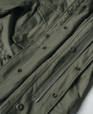 US Army M-65 field jacket, olive front with snap buttons, flap pockets, and zipper