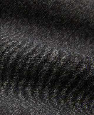 Salt and pepper trousers fabric close-up with fine speckled texture