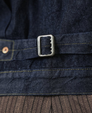 Indigo denim jacket button tab with dark metal snap and contrast topstitching