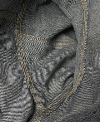 Indigo selvedge denim jacket lining and seam, contrast yellow stitching visible