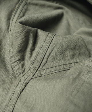 Olive fatigue jacket with stitched shoulder yoke and pocket flap