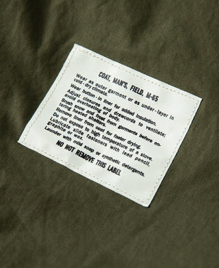 1969 M-65 field jacket interior care label on olive green fabric