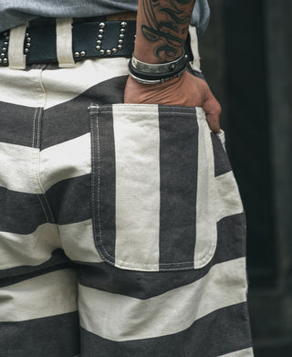 Wide striped prisoner pants detail, white and black stripes with pocket panel and stitching.