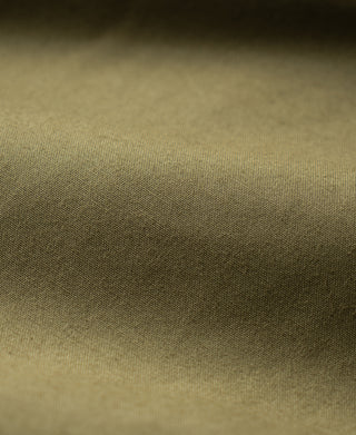 Khaki green flight jacket fabric close-up, woven texture