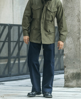 Navy military-style officer trousers with side pleats and tailored fit