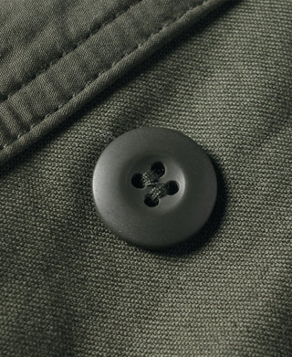 US Army M-65 field jacket, olive fabric with round front button close-up