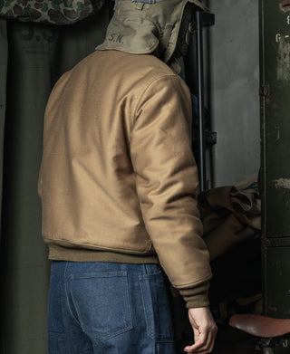 Khaki deck jacket worn with jeans, back view