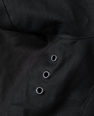 Black waxed chore jacket inner placket with three metal eyelets