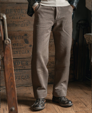 Brown textured pants with straight legs and cuffs, worn with dark lace-up shoes