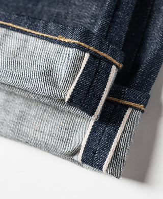 Interior waist label and size tag on dark blue selvedge denim jeans