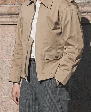 Khaki flight jacket with zip front, button pockets, and cuff detail